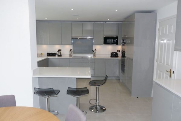 J Groove dove grey gloss kitchen and quartz worktop and breakfast bar fleet